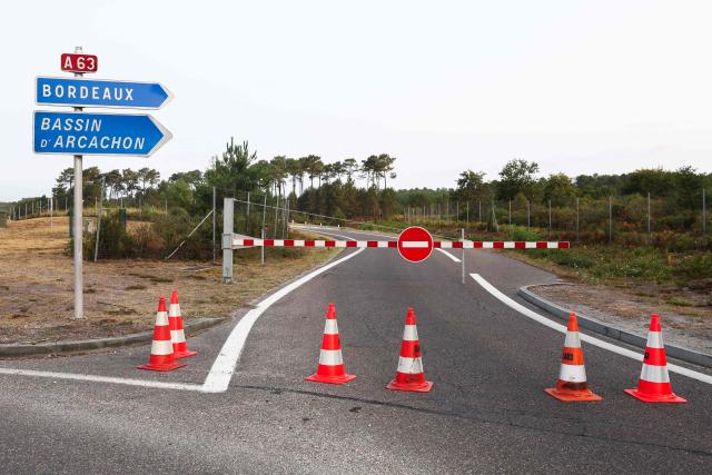 This photograph shows the closed A63 highway near Belin-Beliet, southern of Bordeaux on July 26, 2026 as a wildfire has been ravaging the forest north of the Arcachon Basin (Gironde) since July 22. The fire that has engulfed the area around the Arcachon Basin and is now threatening the outskirts of the Bordeaux metropolitan area has destroyed 42,000 hectares of "burned area," the Gironde prefecture announced; the prefecture has evacuated a total of 220,000 people since July 22. (Photo by ROMAIN PERROCHEAU / AFP)