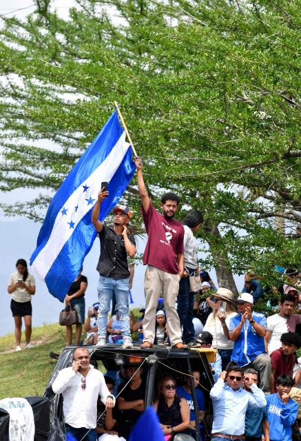 Supporters of former Honduras' President (2014-2022) Juan Orlando Hernandez attend a welcome event at an estate, in Comayagua, 80 km north of Tegucigalpa, on July 26, 2026. Hernandez returned to Honduras on a private flight to face corruption charges after being pardoned last year by US President Donald Trump following a 45-year drug trafficking sentence, ahead of a presidential election won by fellow conservative Nasry Asfura. (Photo by Orlando SIERRA / AFP)