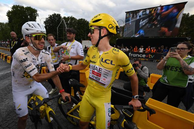 UAE Team Emirates - XRG's Slovenian rider Tadej Pogacar celebrates his overall victory with UAE Team Emirates - XRG's British rider Adam Yates after the 21st stage of the 113th edition of the Tour de France cycling race, 88,7 km starting and finishing in Paris, on July 26, 2026. (Photo by Dario Belingheri / POOL / AFP)