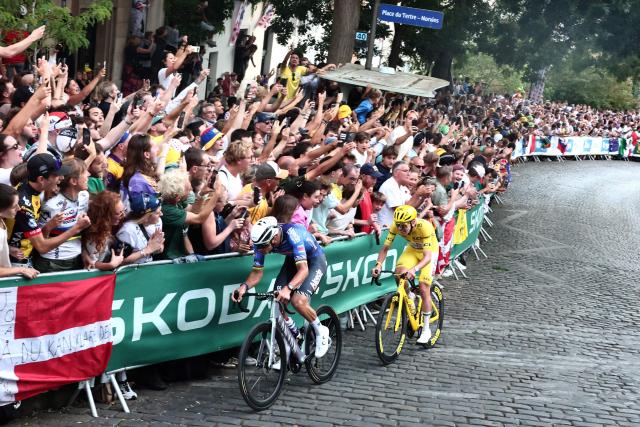 UAE Team Emirates - XRG's Slovenian rider Tadej Pogacar, wearing the overall leader yellow jersey, and Alpecin - Premier Tech team's Dutch rider Mathieu van der Poel cycle in a breakaway atop the Butte de Montmartre during the 21st stage of the 113th edition of the Tour de France cycling race, 88,7 km starting and finishing in Paris, on July 26, 2026. (Photo by Xavier GALIANA / AFP)
