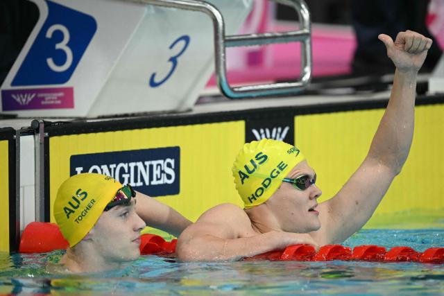Australia's Timothy Hodge (R) reacts after winning the Men's S9 100m Backstroke Final during the swimming event at the Tollcross International Swimming Centre in Glasgow, on day three of the Commonwealth Games in Glasgow, Scotland, on July 26, 2026. (Photo by Oli SCARFF / AFP)