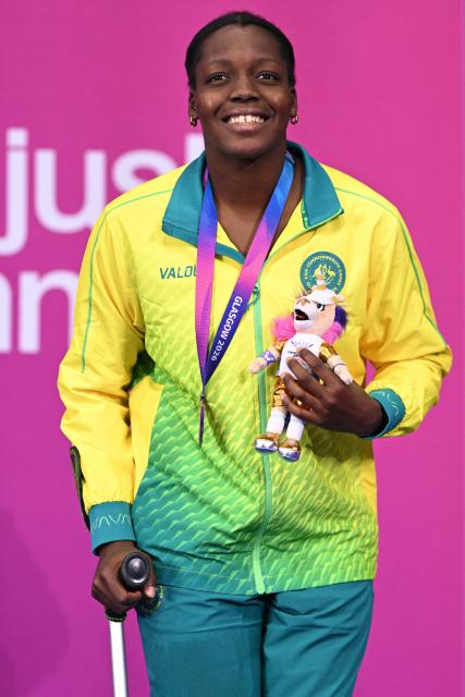 Australia's Victoria Belando Nicholson celebrate  celebrates with their bronze medal during the Women's 100m Backstroke S9 medal ceremony during the swimming event at the Tollcross International Swimming Centre in Glasgow, on day three of the Commonwealth Games in Glasgow, Scotland, on July 26, 2026. (Photo by Oli SCARFF / AFP)