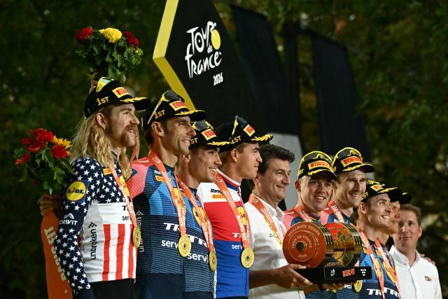 Lidl - Trek team riders celebrate their best team award on the podium after the 21st stage of the 113th edition of the Tour de France cycling race, 130 km between Thoiry and Paris in northern France, on July 26, 2026. (Photo by Loic VENANCE / AFP)