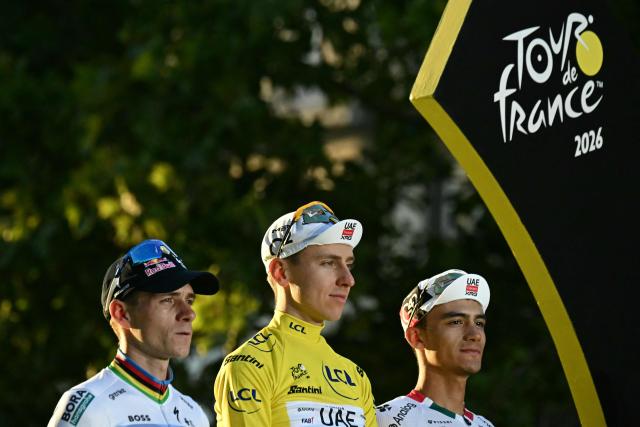 Overall winner UAE Team Emirates - XRG's Slovenian rider Tadej Pogacar celebrates on the on the podium with second-placed Red Bull - BORA - hansgrohe team's Belgian rider Remco Evenepoel and third-placed UAE Team Emirates - XRG's Mexican rider Isaac Del Toro after the 21st stage of the 113th edition of the Tour de France cycling race, 88,7 km starting and finishing in Paris, on July 26, 2026. (Photo by Loic VENANCE / AFP)