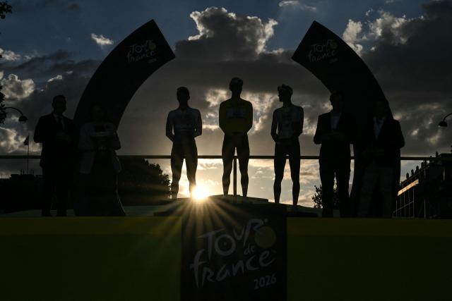 Overall winner UAE Team Emirates - XRG's Slovenian rider Tadej Pogacar celebrates on the on the podium with second-placed Red Bull - BORA - hansgrohe team's Belgian rider Remco Evenepoel and third-placed UAE Team Emirates - XRG's Mexican rider Isaac Del Toro after the 21st stage of the 113th edition of the Tour de France cycling race, 88,7 km starting and finishing in Paris, on July 26, 2026. (Photo by Jeff PACHOUD / AFP)