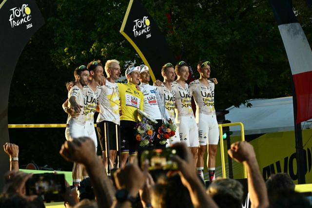 UAE Team Emirates - XRG's Slovenian rider Tadej Pogacar celebrates with his team on the podium with the overall leader's yellow jersey after the 21st stage of the 113th edition of the Tour de France cycling race, 88,7 km starting and finishing in Paris, on July 26, 2026. (Photo by Loic VENANCE / AFP)
