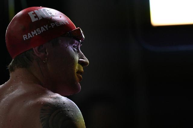 England's Adam Ramsay-Peaty is interviewed after the Men's 50m Breaststroke Semi-Final during the swimming event at the Tollcross International Swimming Centre in Glasgow, on day three of the Commonwealth Games in Glasgow, Scotland, on July 26, 2026. (Photo by Oli SCARFF / AFP)