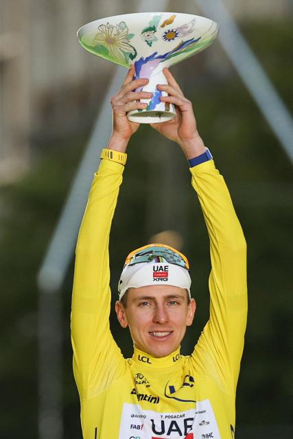 UAE Team Emirates - XRG's Slovenian rider Tadej Pogacar celebrates on the podium with the overall leader's yellow jersey after the 21st stage of the 113th edition of the Tour de France cycling race, 88,7 km starting and finishing in Paris, on July 26, 2026. (Photo by Anne-Christine POUJOULAT / AFP)
