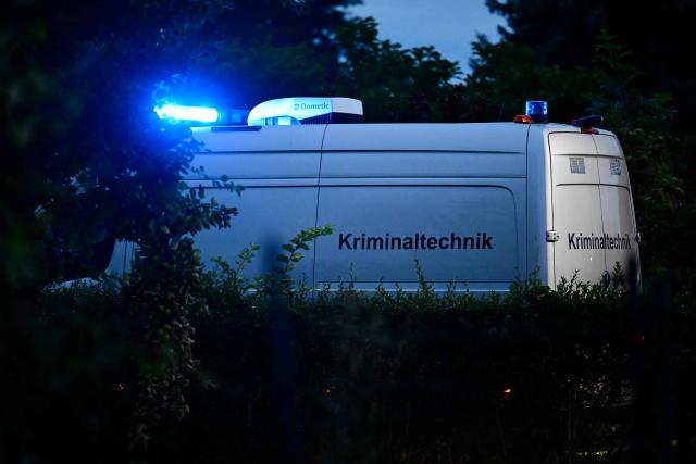 A police van of forensic science (Kriminaltechnik) drives towards the scene in an allotment complex in the western Spandau district of Berlin on July 26, 2026, in a garden area near where the chief suspect in the previous nights' deadly attack near Berlin's Pride parade has been shot dead. German police searched on July 26, 2026 for a suspect believed linked to Islamist circles after a car ploughed into a crowd near Berlin's Gay Pride celebrations, killing one person and wounding 16 others. The incident shattered what had been a day of celebration for hundreds of thousands attending Christopher Street Day, one of Europe's largest Pride events, and left revellers fleeing a central Berlin park as sirens echoed through the night. (Photo by John MACDOUGALL / AFP)