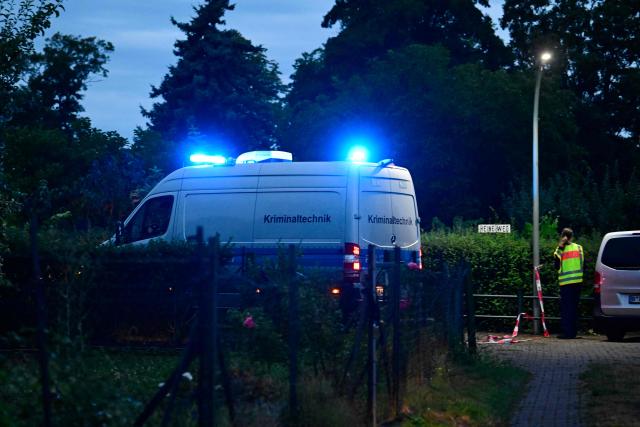 A police van of forensic science (Kriminaltechnik) drives towards the scene in an allotment complex in the western Spandau district of Berlin on July 26, 2026, in a garden area near where the chief suspect in the previous nights' deadly attack near Berlin's Pride parade has been shot dead. German police searched on July 26, 2026 for a suspect believed linked to Islamist circles after a car ploughed into a crowd near Berlin's Gay Pride celebrations, killing one person and wounding 16 others. The incident shattered what had been a day of celebration for hundreds of thousands attending Christopher Street Day, one of Europe's largest Pride events, and left revellers fleeing a central Berlin park as sirens echoed through the night. (Photo by John MACDOUGALL / AFP)