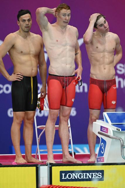 England swimmers react during the Men's 4 x 200m Freestyle Relay Final during the swimming event at the Tollcross International Swimming Centre in Glasgow, on day three of the Commonwealth Games in Glasgow, Scotland, on July 26, 2026. (Photo by Oli SCARFF / AFP)
