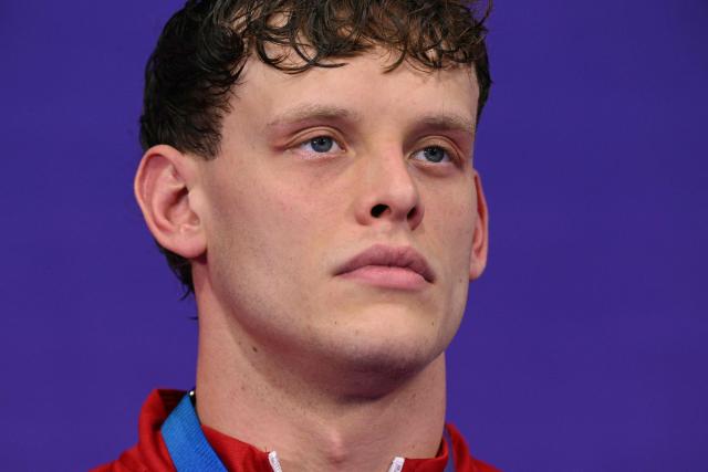 Bronze medallist Wales' Matt Richards stands during the medal ceremony for the Men's 4 x 200m Freestyle Relay at the swimming event at the Tollcross International Swimming Centre in Glasgow, on day three of the Commonwealth Games in Glasgow, Scotland, on July 26, 2026. (Photo by Oli SCARFF / AFP)