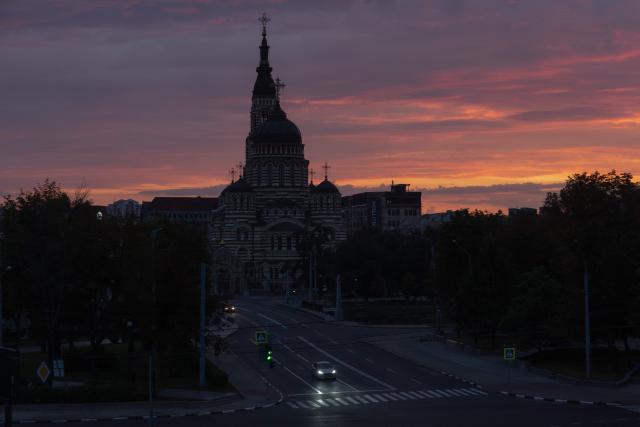 A car drives on a road in front of the Annunciation Cathedral in Ukraine's eastern city of Kharkiv on July 25, 2026, amid the Russian invasion of Ukraine. (Photo by Roman PILIPEY / AFP)