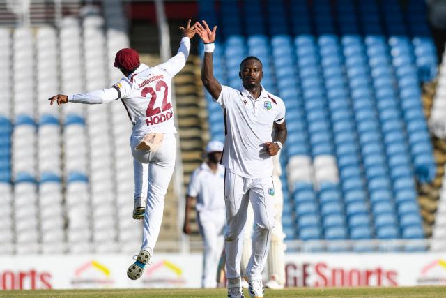 Jayden Seales (R) and Kavem Hodge (L) of West Indies celebrate the dismissal of Babar Azam of Pakistan during the 2nd day of 1st Test match between West Indies and Pakistan at Brian Lara Cricket Academy in Tarouba, Trinidad and Tobago on July 26, 2026. (Photo by Randy Brooks / AFP)