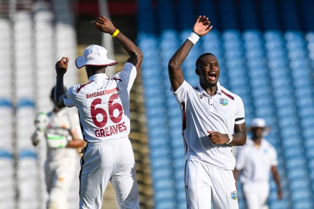 Jayden Seales (R) and Justin Greaves (L) of West Indies celebrate the dismissal of Babar Azam of Pakistan during the 2nd day of 1st Test match between West Indies and Pakistan at Brian Lara Cricket Academy in Tarouba, Trinidad and Tobago on July 26, 2026. (Photo by Randy Brooks / AFP)