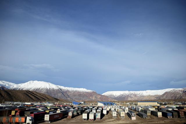 Trucks are pictured awaiting the reopening of the highway affected due to several snow storms near the Argentina-Chile border in Uspallata, Medonza province, Argentina on July 26, 2026. Snowfall is forecasted for the next few days on the Andes mountains forcing the clousure of the international road between Argentina and Chile where dozens of trucks are stranded according to local authorities. (Photo by Andres LARROVERE / AFP)