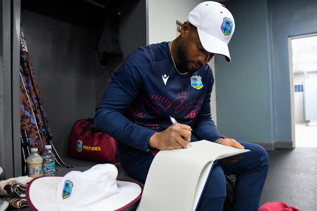 West Indies wicketkeeper Shai Hope signs the condolence book for the late cricket legend Sir Garfield Sobers at the end of the second day of first Test cricket match between West Indies and Pakistan at the Brian Lara Cricket Academy in Tarouba, Trinidad and Tobago, on July 26, 2026. Sir Garfield Sobers, widely regarded as cricket's most outstanding all-rounder, died aged 89 on July 17, 2026, sparking a flood of tributes from all over the cricket world to the Barbadian. (Photo by Randy Brooks / AFP)