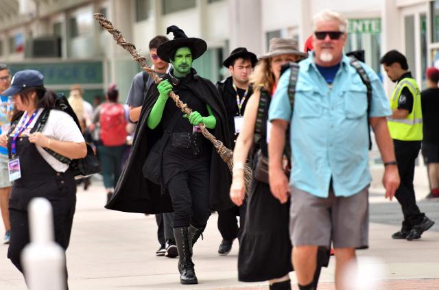 A cosplayer dressed in an Elphaba, of the movie "Wicked", costume walks outside the convention center during Comic-Con International in San Diego, California, on July 26, 2026. (Photo by Chris DELMAS / AFP)