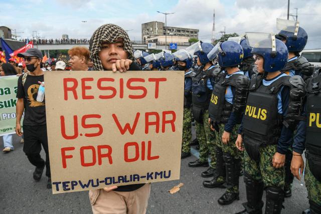 Protesters carrying placards march during a demonstration ahead of Philippine President Ferdinand Marcos’ State of the Nation Address at the House of Representatives in Quezon City, suburban Manila on July 27, 2026. (Photo by TED ALJIBE / AFP)