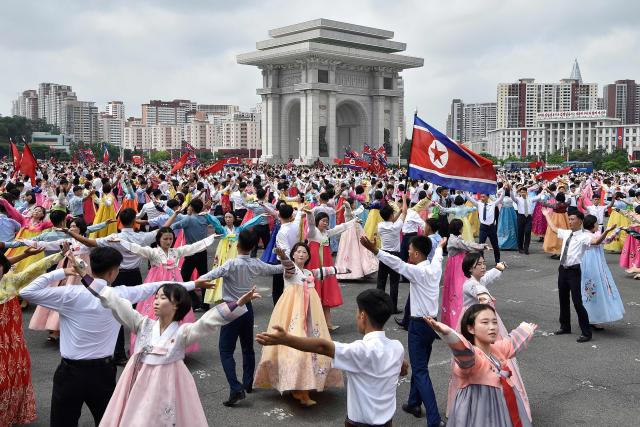 Youth and students dance at the plaza of the Arch of Triumph to mark the 73rd anniversary of the end of the Korean War in Pyongyang on July 27, 2026. (Photo by KIM Won Jin / AFP)