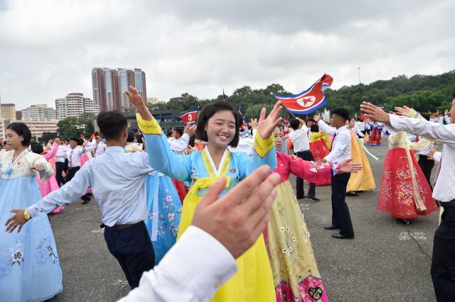 Youth and students dance at the plaza of the Arch of Triumph to mark the 73rd anniversary of the end of the Korean War in Pyongyang on July 27, 2026. (Photo by KIM Won Jin / AFP)