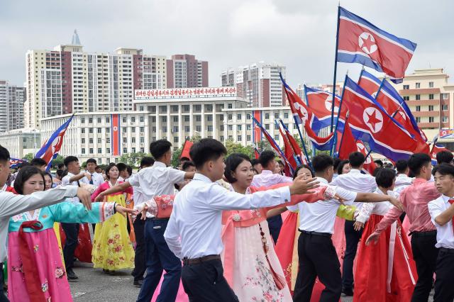 Youth and students dance at the plaza of the Arch of Triumph to mark the 73rd anniversary of the end of the Korean War in Pyongyang on July 27, 2026. (Photo by KIM Won Jin / AFP)