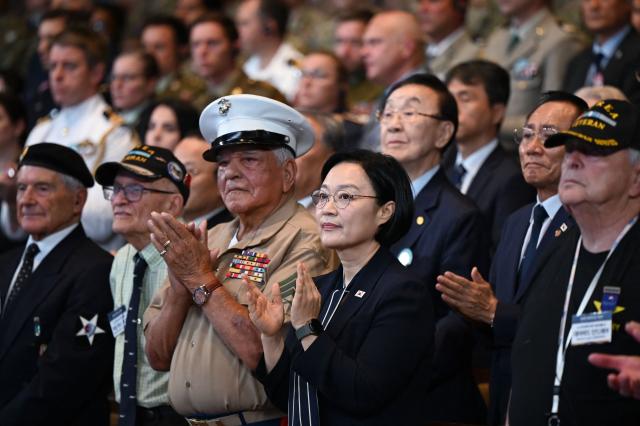South Korean Prime Minister Han Seong-sook (C) applauds with United Nations veterans of the Korean War during a national ceremony for the Korean War UN Veterans Day in Seoul on July 27, 2026. (Photo by GREG BAKER / AFP)