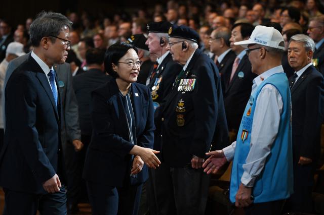 South Korean Prime Minister Han Seong-sook (C) greets Phlippines veteran of the Korean War Prudencio Monta Manuel during a national ceremony for the Korean War UN Veterans Day in Seoul on July 27, 2026. (Photo by GREG BAKER / AFP)