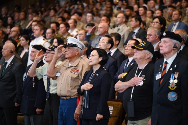 South Korean Prime Minister Han Seong-sook (C) stands with United Nations veterans of the Korean War as the South Korean national anthem is played during a national ceremony for the Korean War UN Veterans Day in Seoul on July 27, 2026. (Photo by GREG BAKER / AFP)
