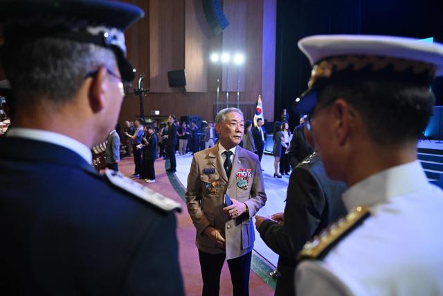 South Korean military officials chat before a national ceremony for the Korean War UN Veterans Day in Seoul on July 27, 2026. (Photo by GREG BAKER / AFP)