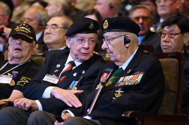 Canadian veteran of the Korean War Andrew Barber (R) chats with British veteran of the war Brian Morley during a national ceremony for the Korean War UN Veterans Day in Seoul on July 27, 2026. (Photo by GREG BAKER / AFP)