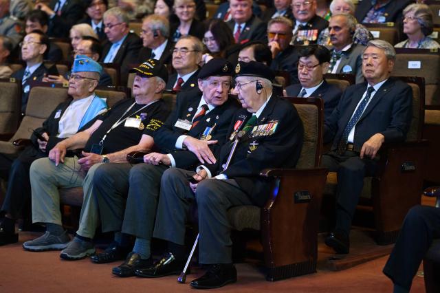 Canadian veteran of the Korean War Andrew Barber (R) chats with British veteran of the war Brian Morley during a national ceremony for the Korean War UN Veterans Day in Seoul on July 27, 2026. (Photo by GREG BAKER / AFP)