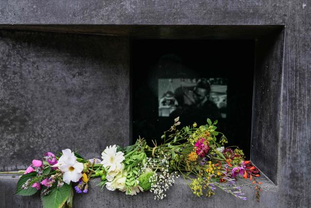 Close-up view showsflowers that are arranged on the "Memorial to the homosexuals persecuted by the Nazis", on July 27, 2026 in Berlin, two days after a car ramming attack that killed one person and injured 29 near the Christopher Street Day (CSD) parade. German police announced on July 26, 2026 that they had shot and killed the chief suspect in what officials described as a deadly Islamist attack near the Berlin Pride parade the night prior, the latest ramming assault to hit the country. The attack late on July 25 -- the first such incident to target the German capital's LGBTQ community, killed one woman and wounded 29 others. (Photo by John MACDOUGALL / AFP)