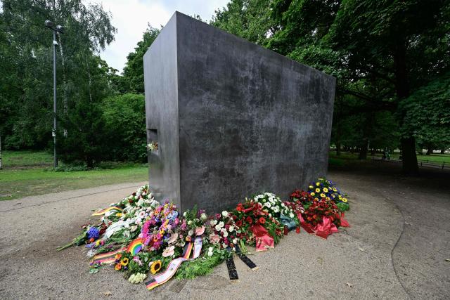 Wreaths and flowers are arranged around the Memorial to the homosexuals persecuted by the Nazis, on July 27, 2026 in Berlin, two days after a car ramming attack that killed one person and injured 29 near the Christopher Street Day (CSD) parade. German police announced on July 26, 2026 that they had shot and killed the chief suspect in what officials described as a deadly Islamist attack near the Berlin Pride parade the night prior, the latest ramming assault to hit the country. The attack late on July 25 -- the first such incident to target the German capital's LGBTQ community, killed one woman and wounded 29 others. (Photo by John MACDOUGALL / AFP)