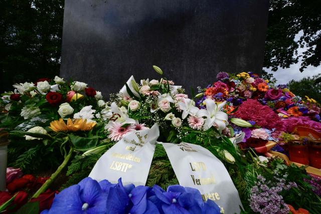Close-up view shows wreaths and flowers that are arranged around the Memorial to the homosexuals persecuted by the Nazis, on July 27, 2026 in Berlin, two days after a car ramming attack that killed one person and injured 29 near the Christopher Street Day (CSD) parade. German police announced on July 26, 2026 that they had shot and killed the chief suspect in what officials described as a deadly Islamist attack near the Berlin Pride parade the night prior, the latest ramming assault to hit the country. The attack late on July 25 -- the first such incident to target the German capital's LGBTQ community, killed one woman and wounded 29 others. (Photo by John MACDOUGALL / AFP)