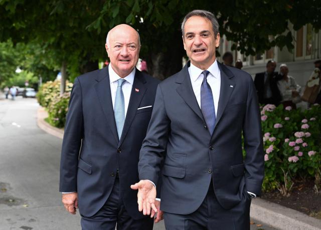 Austrian Chancellor Christian Stocker (L) welcomes Greek Prime Minister Kyriakos Mitsotakis for a meeting on the sidelines of the Salzburg Festival 2026 in Salzburg, Austria, on July 27, 2026. (Photo by BARBARA GINDL / APA / AFP) / Austria OUT