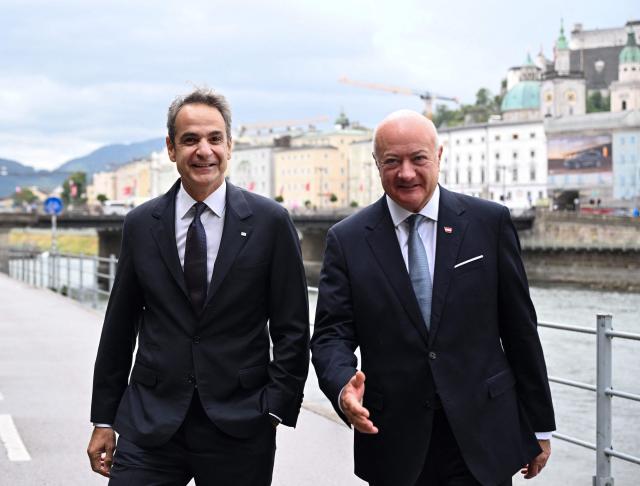 Austrian Chancellor Christian Stocker (R) welcomes Greek Prime Minister Kyriakos Mitsotakis for a meeting on the sidelines of the Salzburg Festival 2026 in Salzburg, Austria, on July 27, 2026. (Photo by BARBARA GINDL / APA / AFP) / Austria OUT