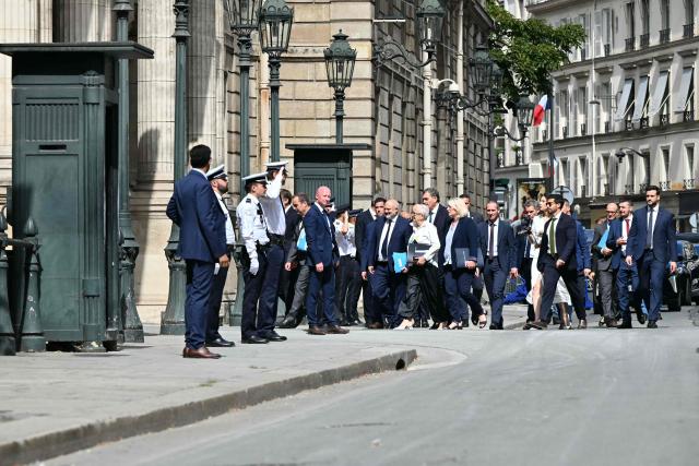 France's Prime Minister Sebastien Lecornu and his arrive for the last weekly cabinet meeting before the summer recess at the Elysee Palace in Paris on July 27, 2026. (Photo by LOU BENOIST / AFP)