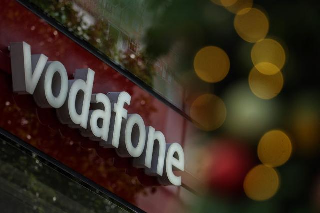 Signage for British telecommunications group Vodafone is pictured outside a shop in central London on July 27, 2026. Vodafone announced on July 27 a nearly 10 percent increase in revenue for the first quarter and raised its forecasts. (Photo by Adrian Dennis / AFP)