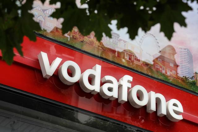 Signage for British telecommunications group Vodafone is pictured outside a shop in central London on July 27, 2026. Vodafone announced on July 27 a nearly 10 percent increase in revenue for the first quarter and raised its forecasts. (Photo by Adrian DENNIS / AFP)