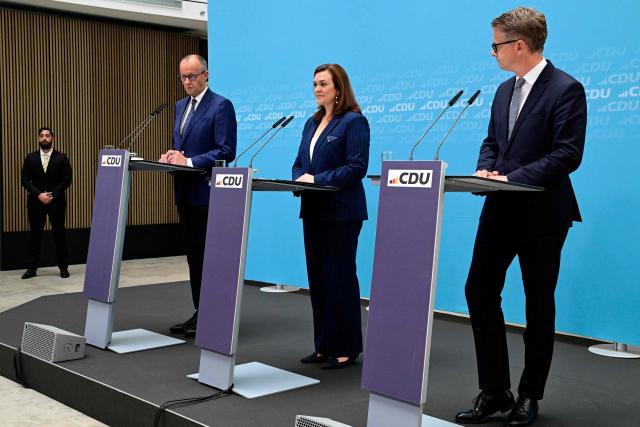 (From L) German Chancellor and CDU chairman Friedrich Merz, outgoing treasurer and designated CDU Secretary General Franziska Hoppermann and outgoing Secretary General and designated German Health Minister Carsten Linnemann address a press conference to announce changes in the German government and within the party, in Berlin on July 27, 2026. (Photo by John MACDOUGALL / AFP)