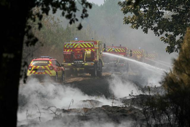 Firefighters carry out mop-up operations, extinguishing remaining hot spots and  smoldering patches, in a forest near Marcheprime, some 30 km from Bordeaux, on July 27, 2026, as a wildfire rages through the forest in Gironde, southwestern France. A massive wildfire in France's Gironde department, home to Bordeaux, remained "broadly stable overnight," the local authority said on July 27, 2026. "The situation remained broadly stable overnight, with no major developments. Security and emergency services remain fully mobilised and are continuing their operations on the ground," the local authority said in a statement. (Photo by Alain JOCARD / AFP)