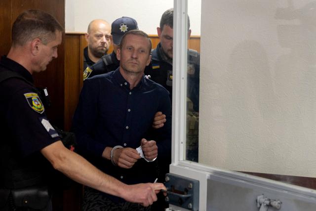 Vasyl Goncharuk, head of the Association of Manufacturers of Unmanned Systems and Related Technologies "Armada" and the main organiser of an event at the training ground targeted by Russian missile strikes on July 24, enters the court room during a hearing in Kyiv on July 27, 2026, to determine a preventive measure against him. (Photo by Tetiana DZHAFAROVA / AFP)