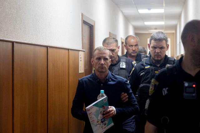 Vasyl Goncharuk, head of the Association of Manufacturers of Unmanned Systems and Related Technologies "Armada" and the main organiser of an event at the training ground targeted by Russian missile strikes on July 24, leaves the courtroom during a hearing in Kyiv on July 27, 2026, to determine a preventive measure against him. (Photo by Tetiana DZHAFAROVA / AFP)