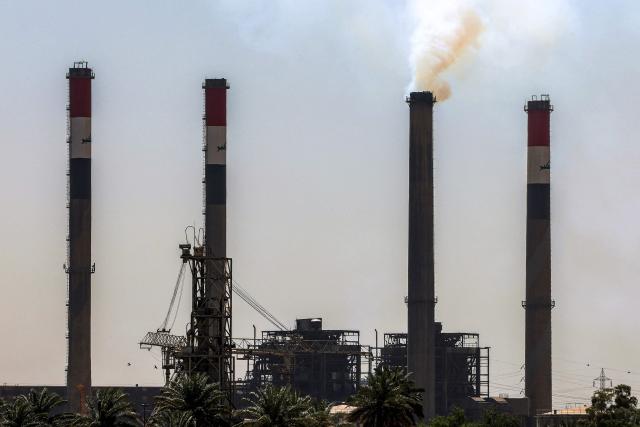 The Dora (Daura) Thermal Power Station in the Dora district of southern Baghdad is pictured on July 27, 2026. In oil-rich Iraq, many households have just a few hours of state electricity per day, and those who can afford it use private generators to keep fridges and air conditioners running. The country is the second-largest oil producer in the OPEC cartel, but despite its immense oil and gas reserves, it remains dependent on imports to meet its electricity needs. (Photo by AHMAD AL-RUBAYE / AFP)