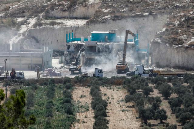Israeli forces oversee the demolition of a building containing shops and flats, citing the lack of a building permit, in Anzah, south of the Palestinian city of Jenin, in the northern Israeli-occupied West Bank on July 27, 2026. (Photo by Mohammad MANSOUR / AFP)