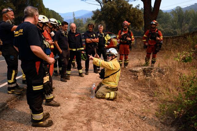 Firefighters prepare to battle a wildfire near the village of Cebreros, Avila province, Spain, on July 27, 2026. Spain faces two crucial days to bring raging wildfires under control before weather conditions worsen, authorities said on July 27, 2026, though they were making some progress and planned to start returning evacuees to certain areas. The fires in the Iberian country have affected an area of 77,000 hectares (190,000 acres) -- nearly the size of New York City -- according to the authorities. Since the start of the year, fires in Spain have ravaged 150,000 hectares and killed 13 people. (Photo by MIGUEL RIOPA / AFP)