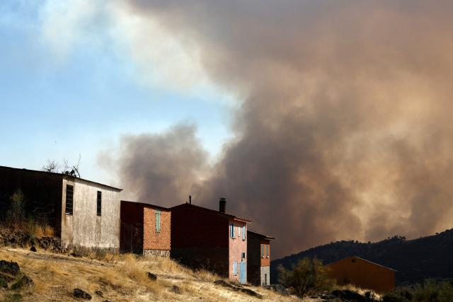 Smoke billows from a wildfire near Robledo de Chavela, about 60 kilometres west of Madrid, on July 27, 2026. Spain faces two crucial days to bring raging wildfires under control before weather conditions worsen, authorities said on July 27, 2026, though they were making some progress and planned to start returning evacuees to certain areas. The fires in the Iberian country have affected an area of 77,000 hectares (190,000 acres) -- nearly the size of New York City -- according to the authorities. Since the start of the year, fires in Spain have ravaged 150,000 hectares and killed 13 people. (Photo by Oscar DEL POZO / AFP)