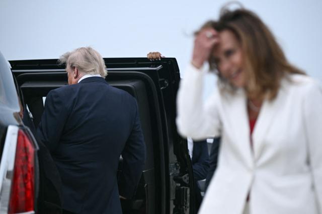 US President Donald Trump walks to his motorcade after exiting Air Force One upon arrival to Oakland County International Airport in Waterford, Michigan, on July 27, 2026. Trump is in Michigan to deliver remarks at General Motors’ vehicle testing site Milford Proving Ground. (Photo by Brendan SMIALOWSKI / AFP)