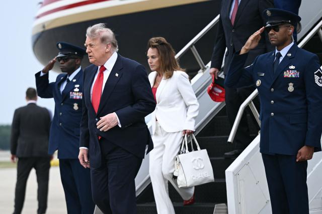 US President Donald Trump and Representative Lisa McClain, Republican from Michigan, step off Air Force One upon arrival to Oakland County International Airport in Waterford, Michigan, on July 27, 2026. Trump is in Michigan to deliver remarks at General Motors’ vehicle testing site Milford Proving Ground. (Photo by Brendan SMIALOWSKI / AFP)